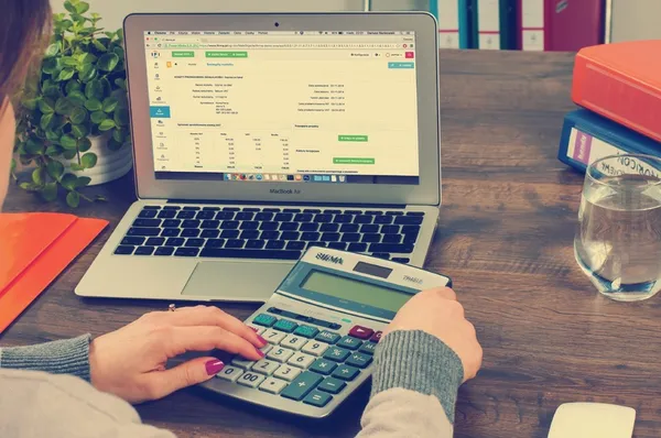 Person calculating the cost of their restaurant reservation subscription