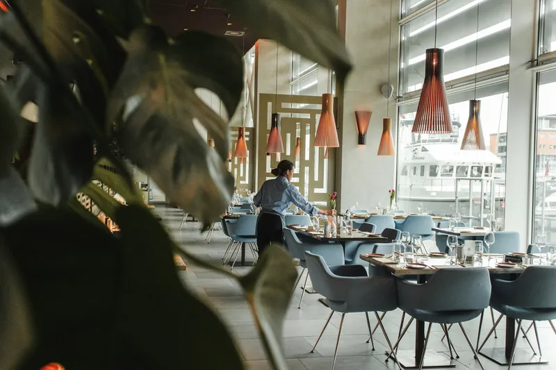 Warm interior of an independent restaurant with set tables